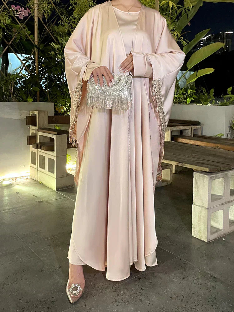 Woman wearing an elegant abaya outer set styled modestly with belt and hijab for a graceful layered look.